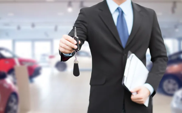 Close up of businessman or salesman giving car key