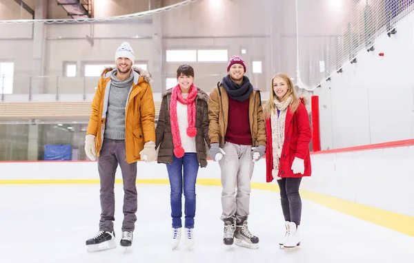 Happy friends on skating rink