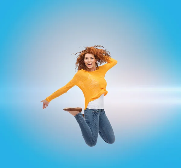 Smiling young woman jumping in air