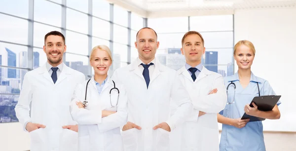 Group of smiling doctors with clipboard