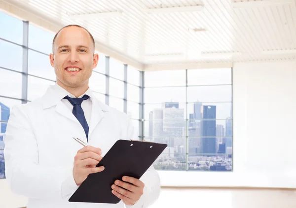 Smiling male doctor with clipboard