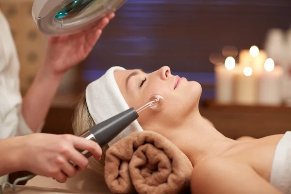 Close up of young woman having face massage in spa