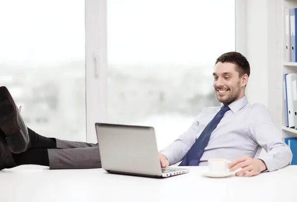 Smiling businessman or student with laptop