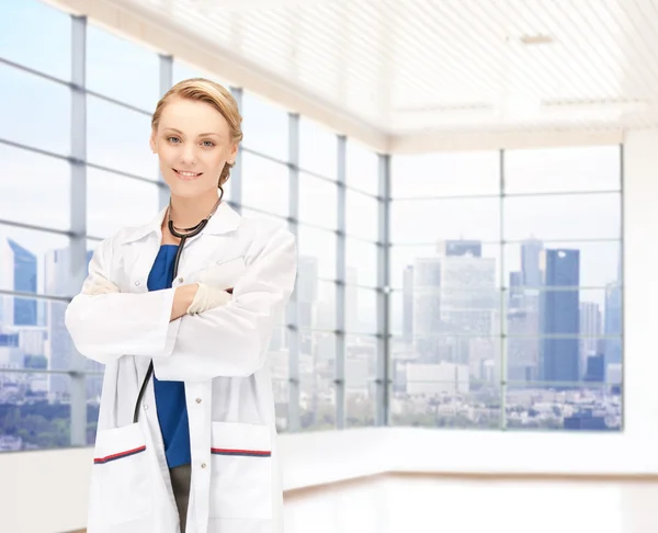 Smiling young female doctor in white coat