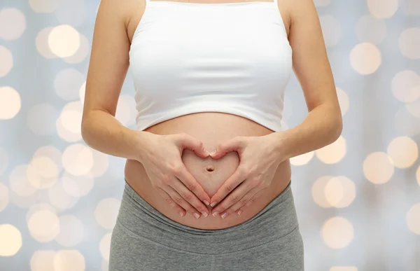 Pregnant woman touching her  tummy