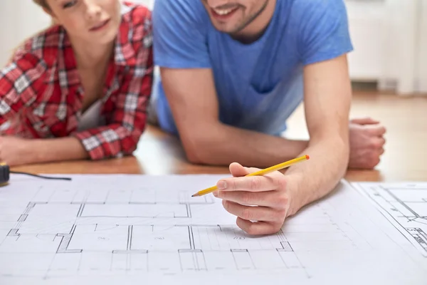 Close up of couple with blueprint at home