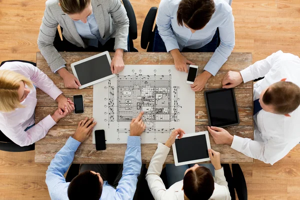 Business team or architects with blueprint