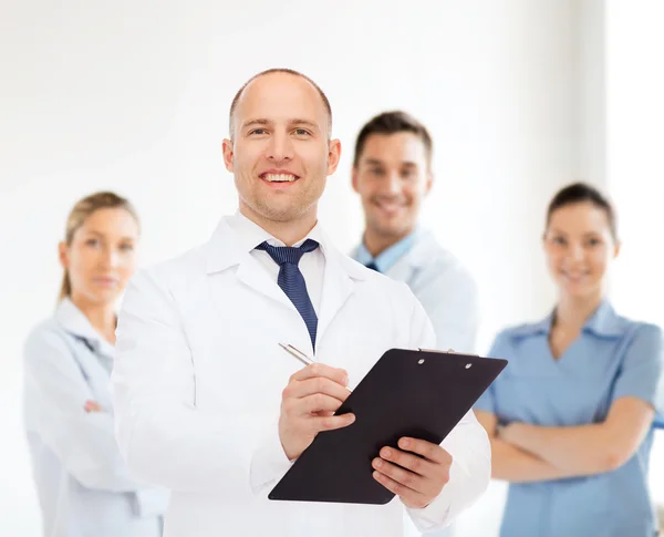 Smiling male doctor with clipboard
