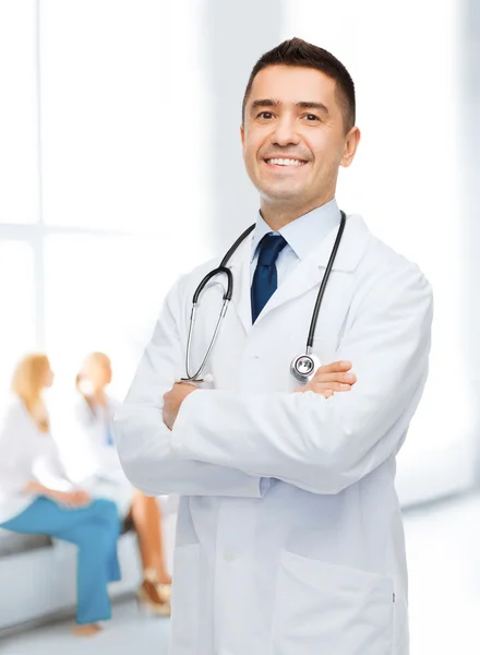 Smiling male doctor in white coat at hospital