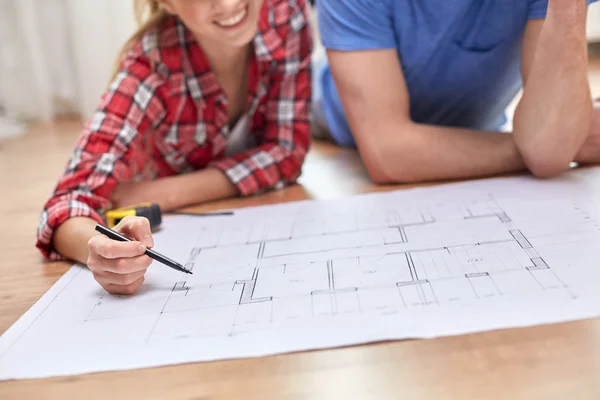 Close up of couple with blueprint at home