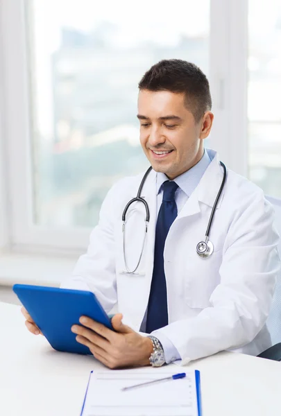 Smiling male doctor in white coat with tablet pc