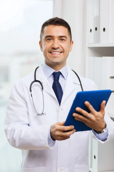 Smiling male doctor in white coat with tablet pc