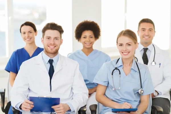 Group of happy doctors on seminar at hospital