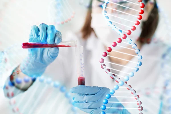 Close up of scientist with tube making test in lab