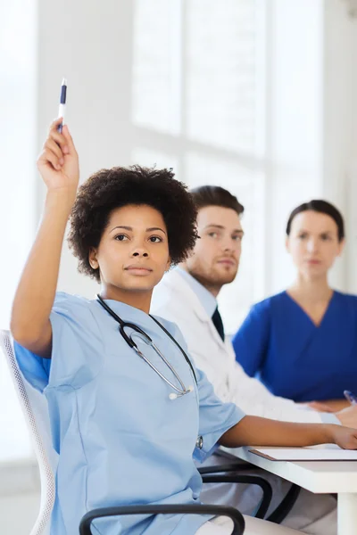 Group of happy doctors on conference at hospital