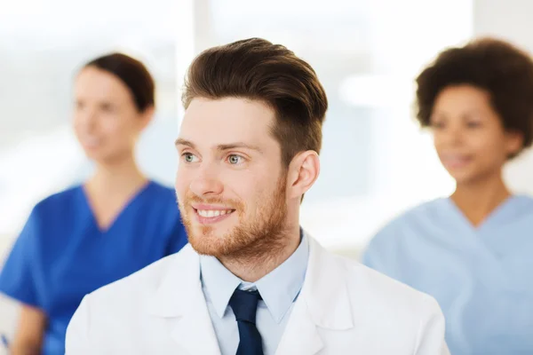 Happy doctor over group of medics at hospital