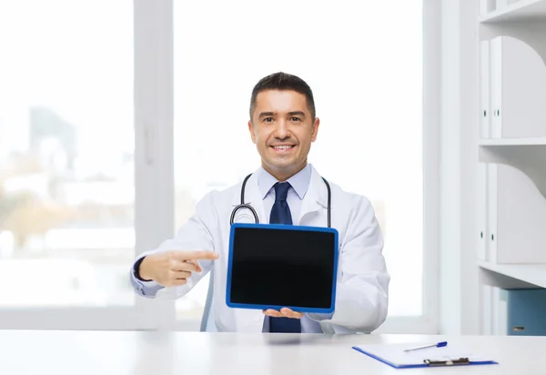 Smiling male doctor showing tablet pc blank screen