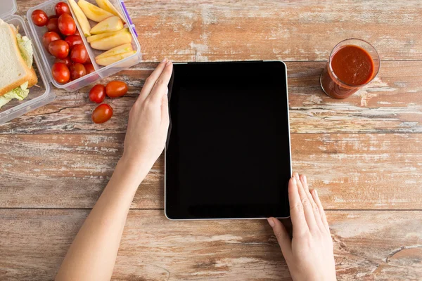 Close up of woman with tablet pc food on table