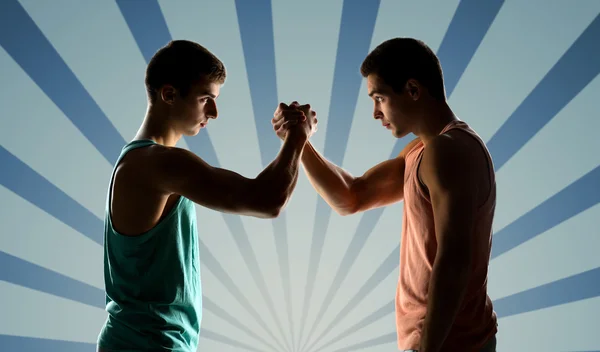 Two young men arm wrestling