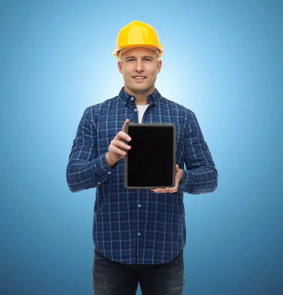 Smiling male builder in helmet with tablet pc