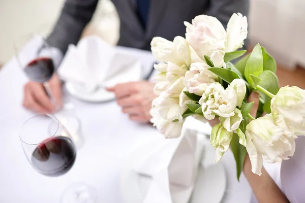 Close up of couple with flowers at restaurant