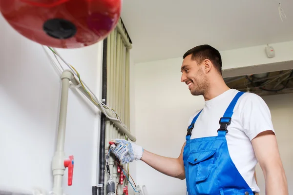 Builder or plumber working indoors