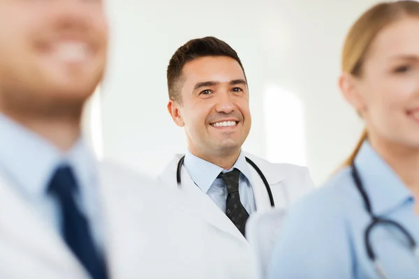 Happy doctor over group of medics at hospital