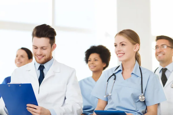 Group of happy doctors on seminar at hospital