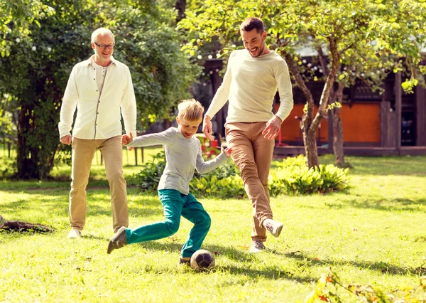 Happy family playing football outdoors