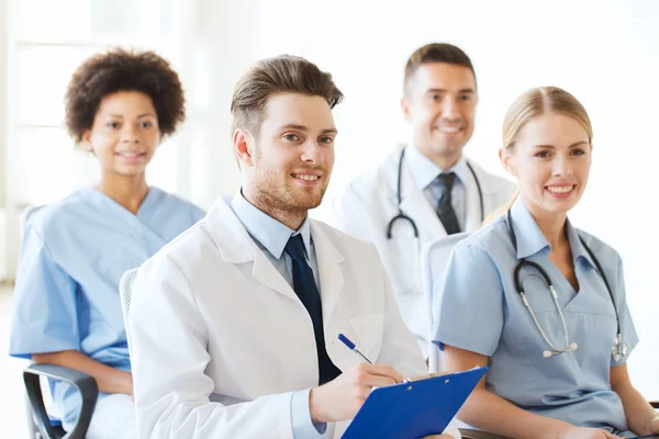 Group of happy doctors on seminar at hospital