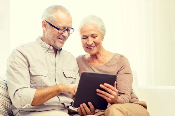 Happy senior couple with tablet pc at home