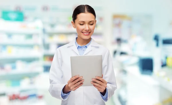 Smiling female doctor with tablet pc at drugstore
