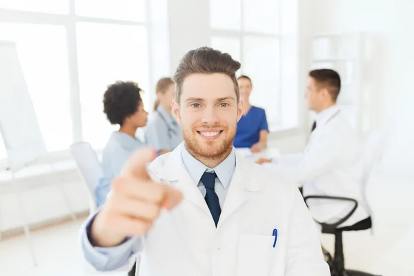 Happy doctor over group of medics at hospital