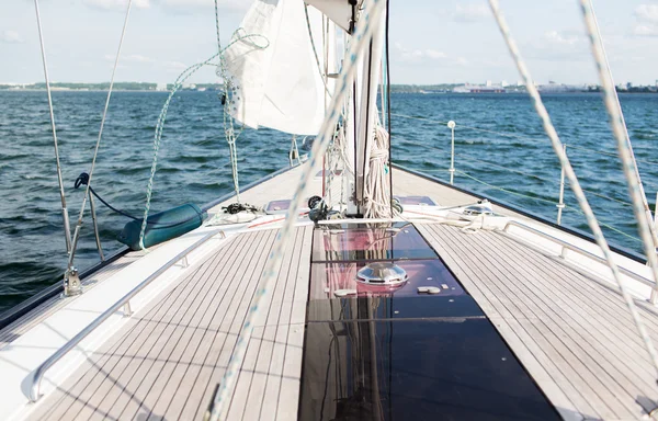 Close up of sailboat or sailing yacht deck and sea