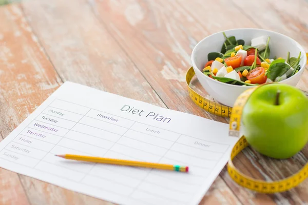 Close up of diet plan and food on table