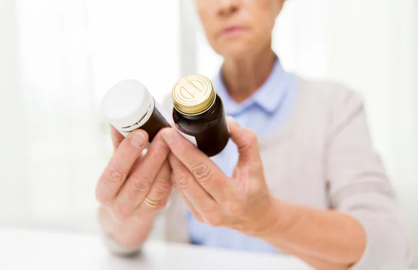 Close up of senior woman with medicine jars
