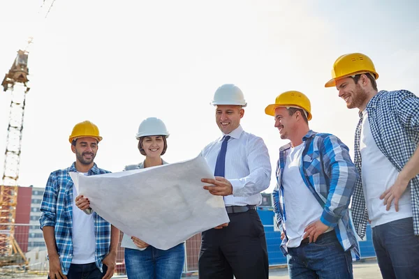 Group of builders and architects with blueprint