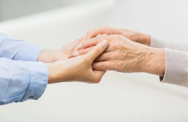 Close up of senior and young woman hands