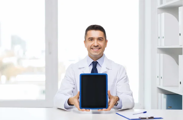 Smiling male doctor showing tablet pc blank screen