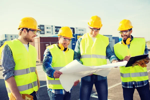 Group of builders with tablet pc and blueprint