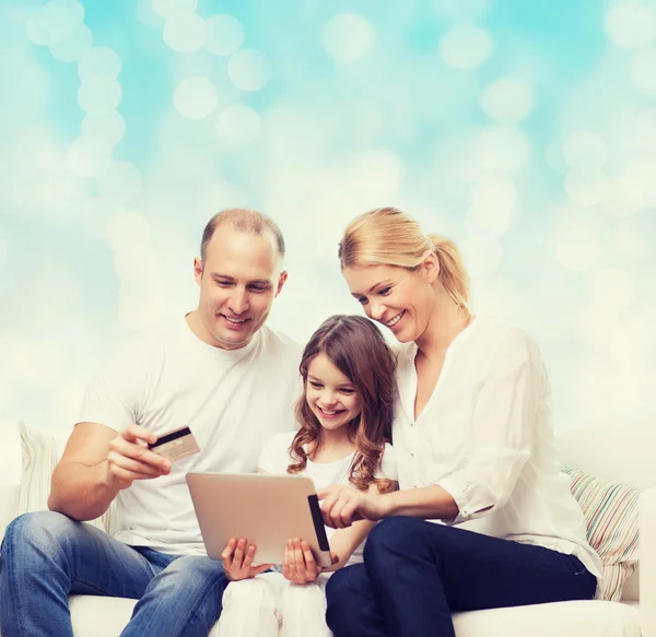 Happy family with tablet pc and credit card