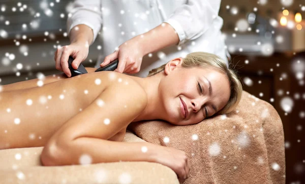 Close up of woman having hot stone massage in spa