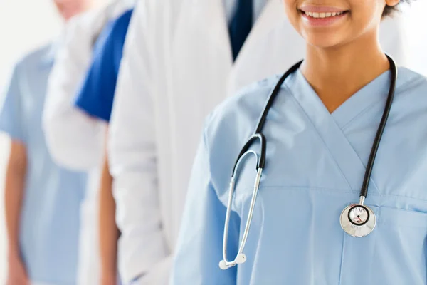 Close up of happy doctor or nurse with stethoscope