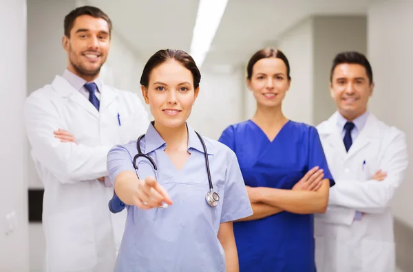 Group of medics pointing finger on you at hospital