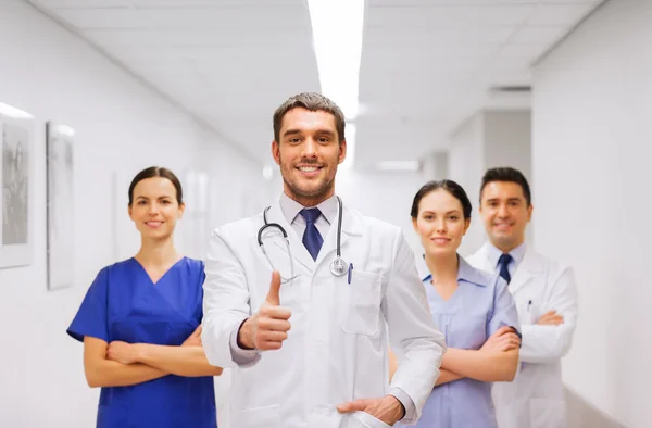 Medics or doctors at hospital showing thumbs up