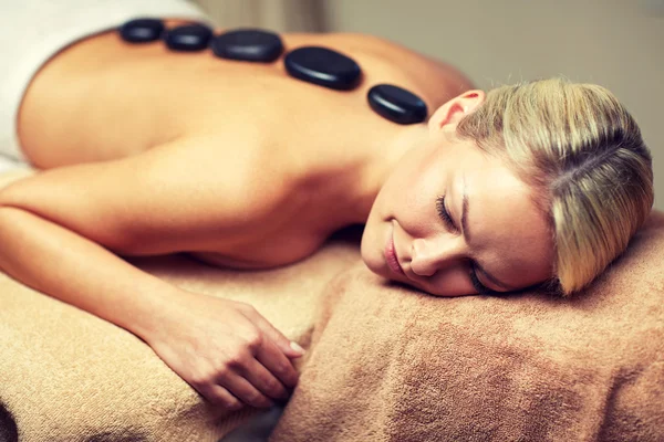 Close up of woman having hot stone massage in spa
