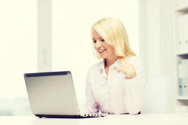 Smiling businesswoman or student with laptop