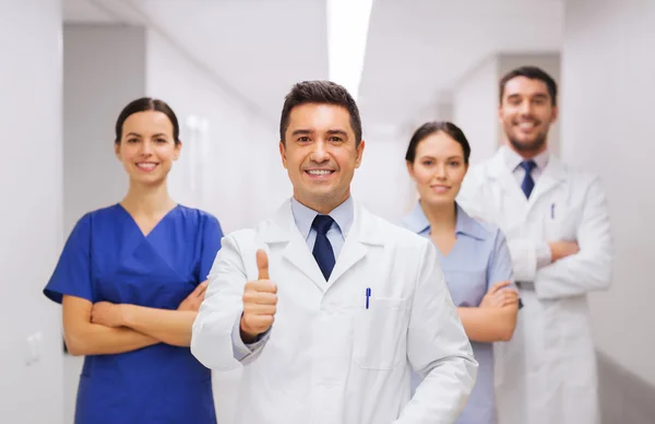 Medics or doctors at hospital showing thumbs up