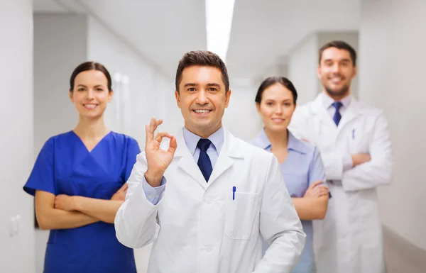 Group of medics at hospital showing ok hand sign