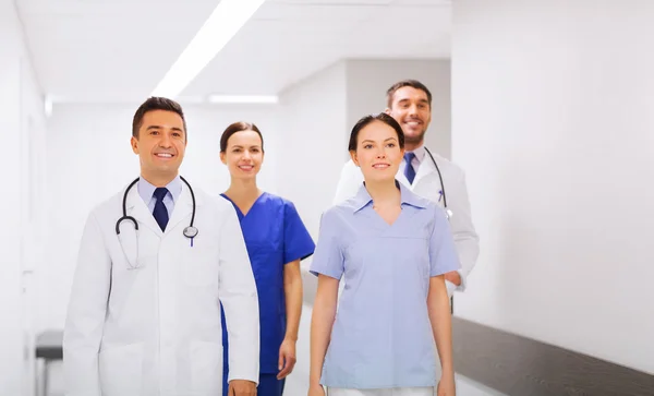 Happy group of medics or doctors at hospital